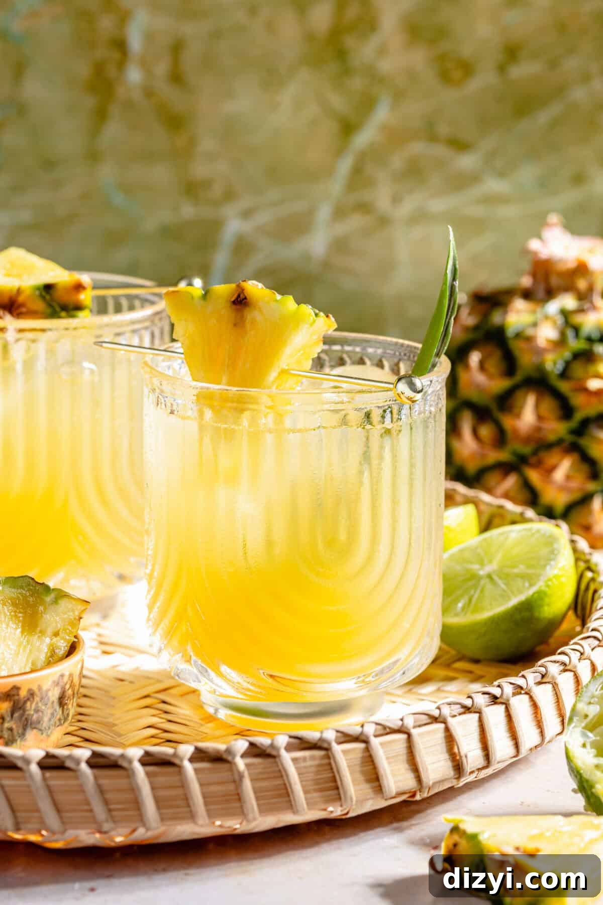 Kauai Margarita: Smoky Pineapple Cocktail Recipe 5 The Kauai Margarita in two glasses on woven tray.