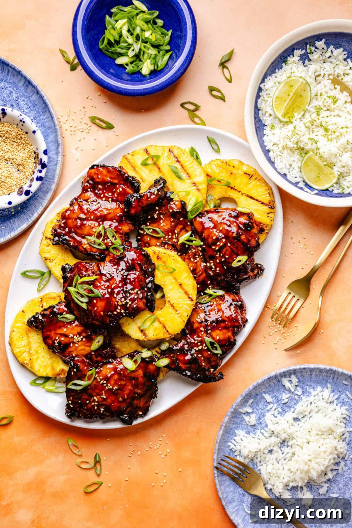 Grilled Huli Huli–Inspired Chicken on platter with pineapple and serving ingredients surrounding.