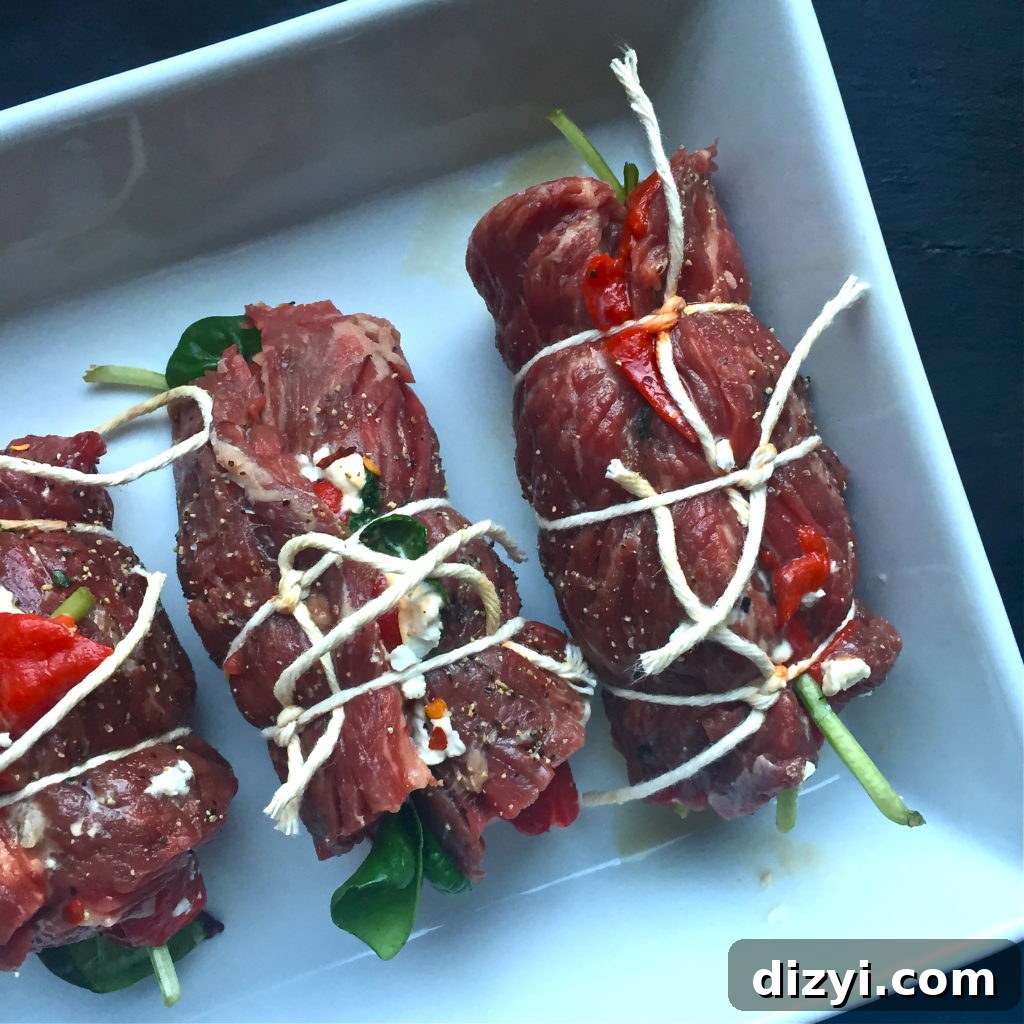 Skirt steak roll-ups with roasted red peppers and goat cheese