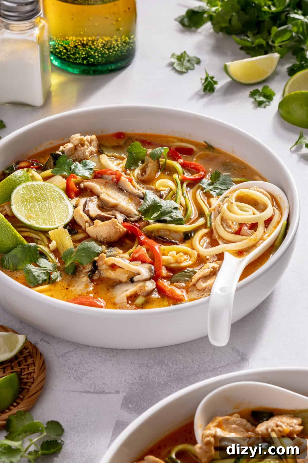 Thai Red Curry Chicken Soup with Zucchini Noodles 3 Thai-Inspired Red Curry Chicken Zoodle Soup in bowl with garnishes.