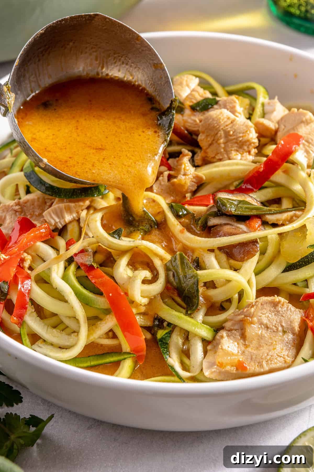 Thai Red Curry Chicken Soup with Zucchini Noodles 6 Thai-Inspired Red Curry Chicken Zoodle Soup being laddled into bowl.