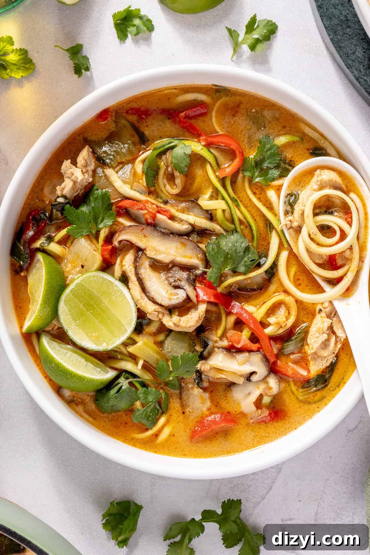 Thai Red Curry Chicken Soup with Zucchini Noodles 7 Thai-Inspired Red Curry Chicken Zoodle Soup in bowl with garnishes
