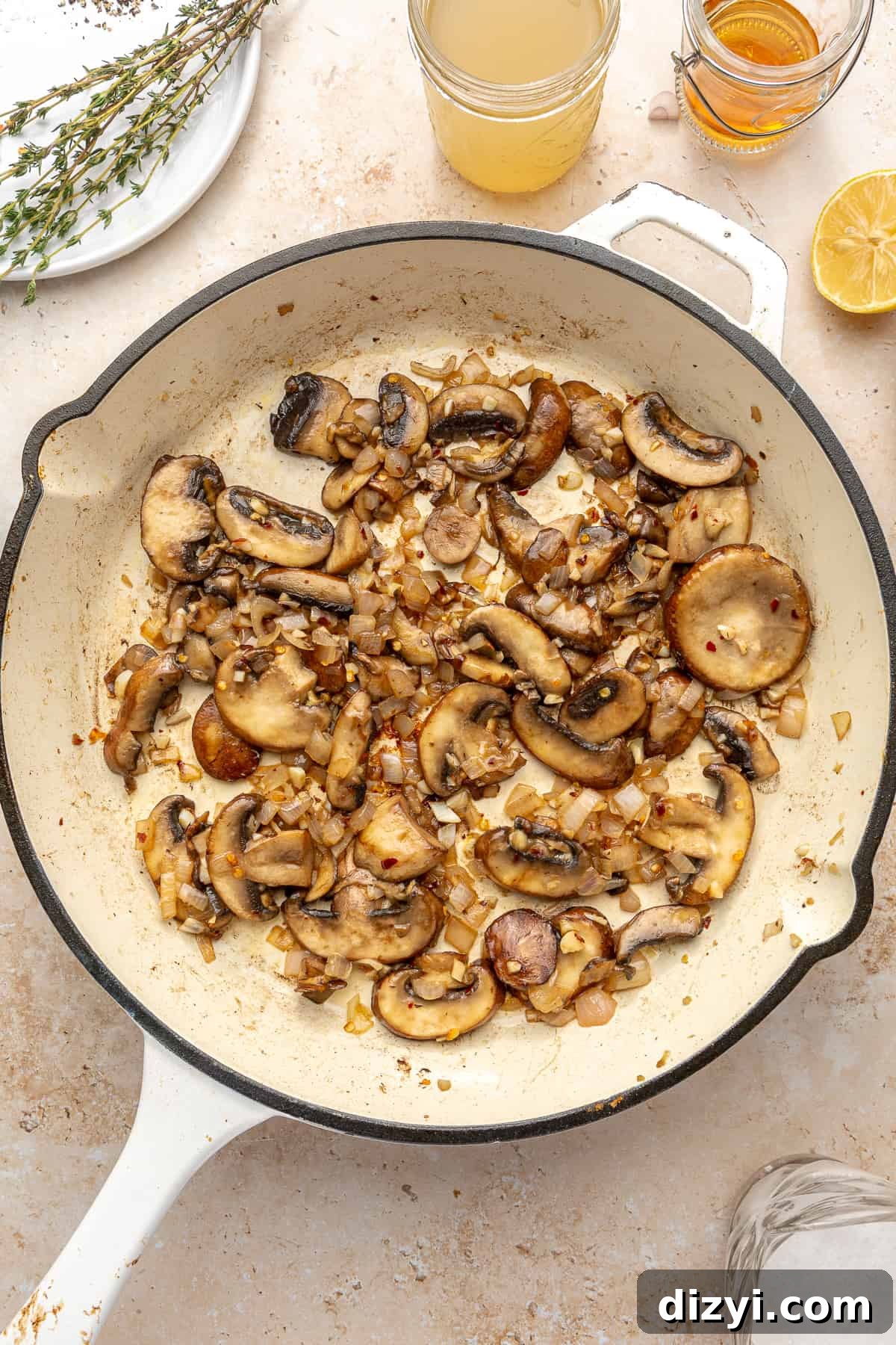 Sautéd mushrooms in white skillet. 