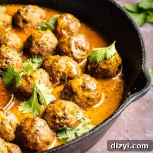 A cast iron skillet with the saucy meatballs and cilantro.