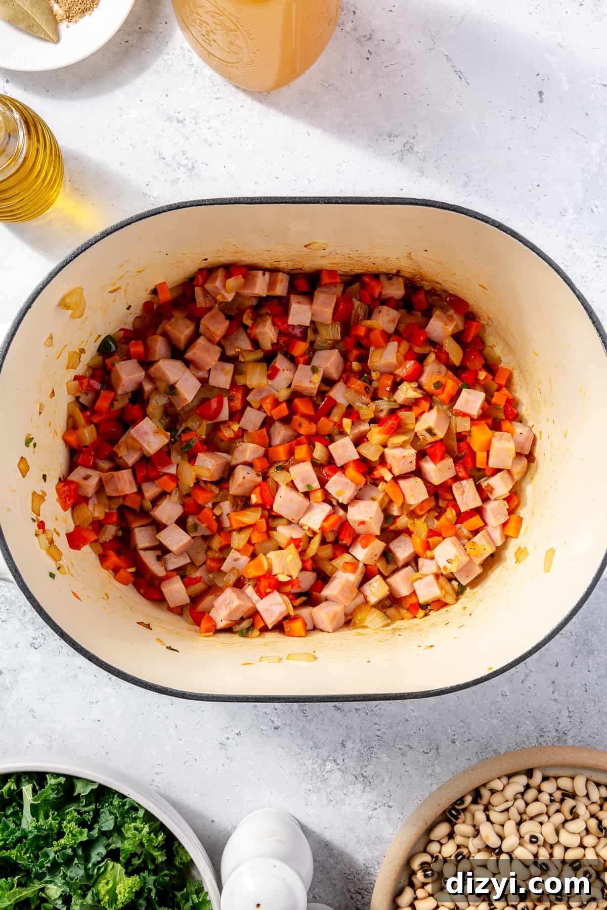 Ham sautéing in veggie mixture in dutch oven.