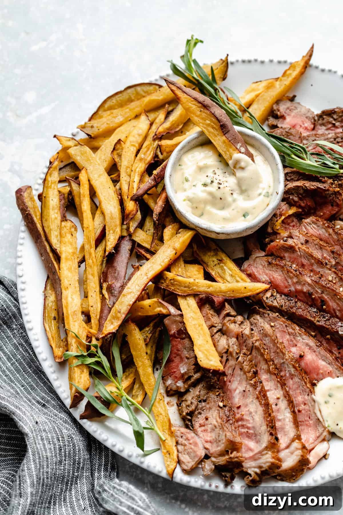 Whole30 Steak Frites Recipe with Tarragon Aioli 3 Sliced ribeye with sweet potato fries and tarragon aioli