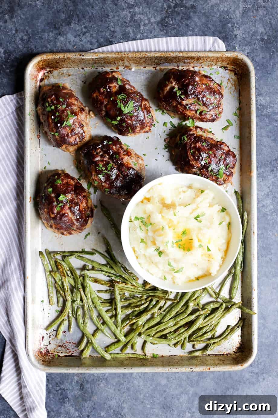 Smoky Mini BBQ Meatloaves with Tangy Glaze 2 Mini BBQ Meatloaves on a baking sheet