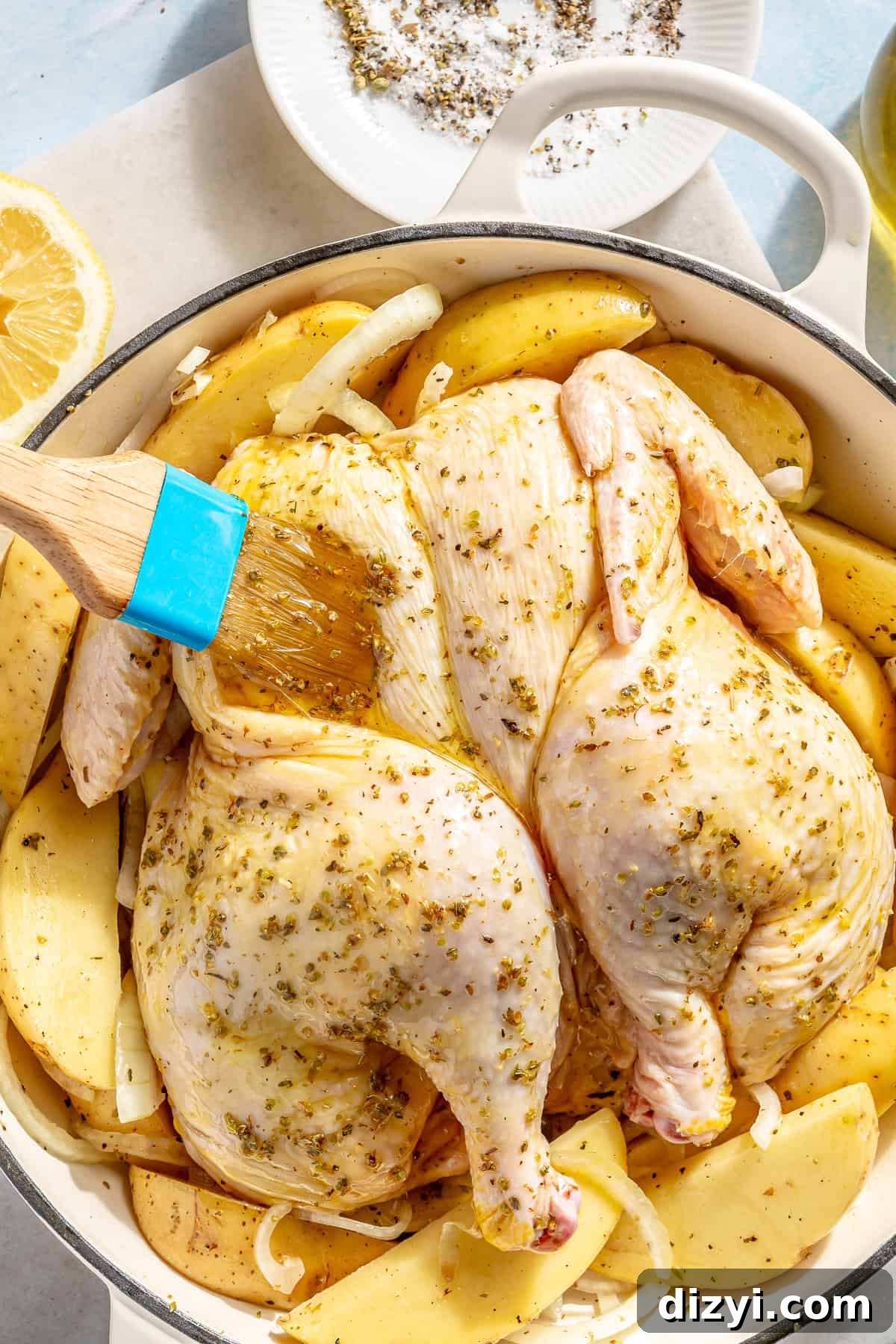 Whole Greek Roast Chicken with Lemon Potatoes 6 Raw chicken chicken brushed with oil and seasoning.