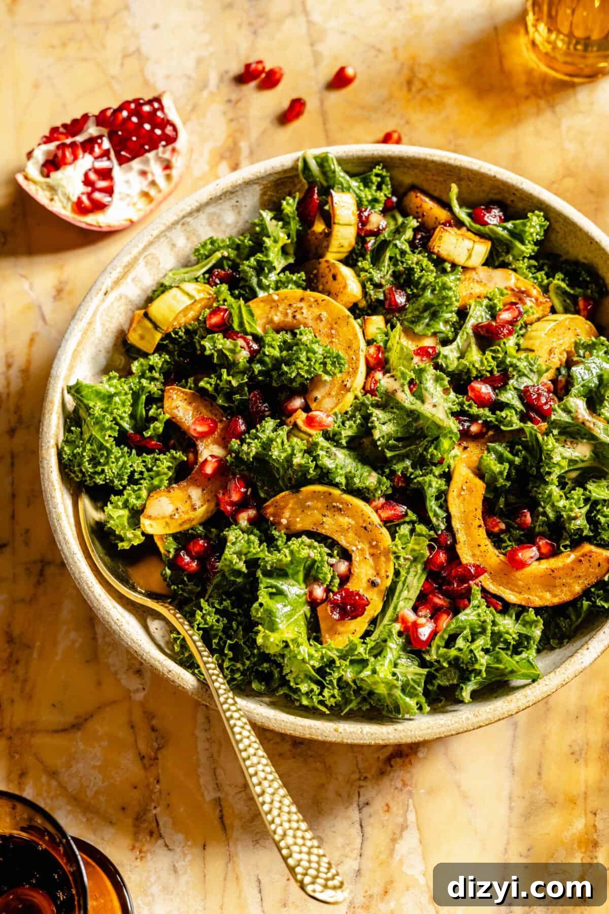 A close up shot of a finished serving dish of Kale Salad with Roasted Delicata Squash and Miso Dressing