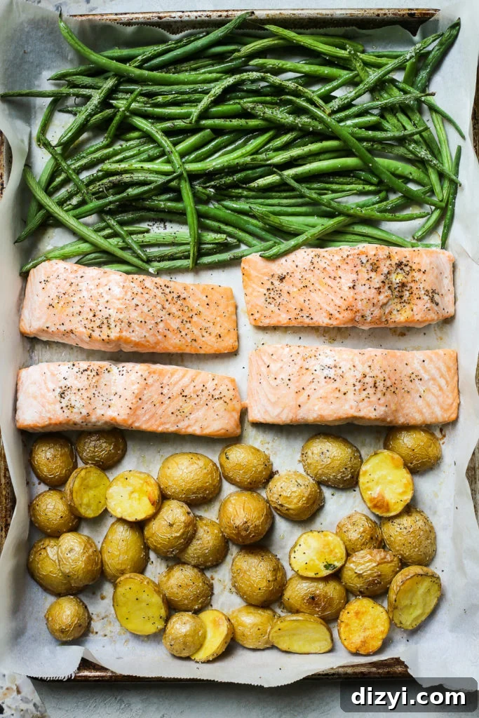 Sheet Pan Salmon Nicoise Salad roasting on a sheet pan