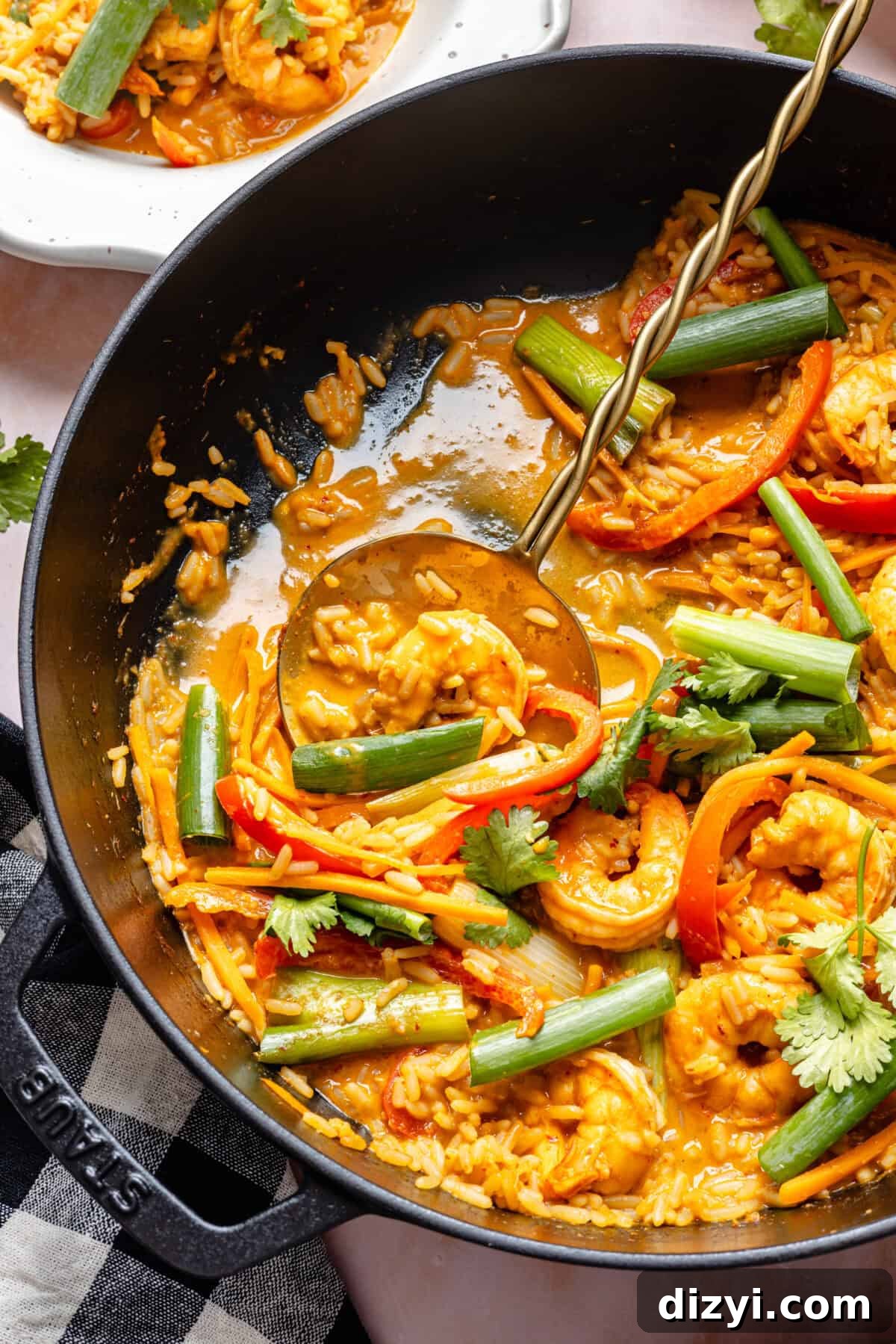 20-Minute Thai-Inspired Coconut Shrimp Curry getting ladeled into bowls.