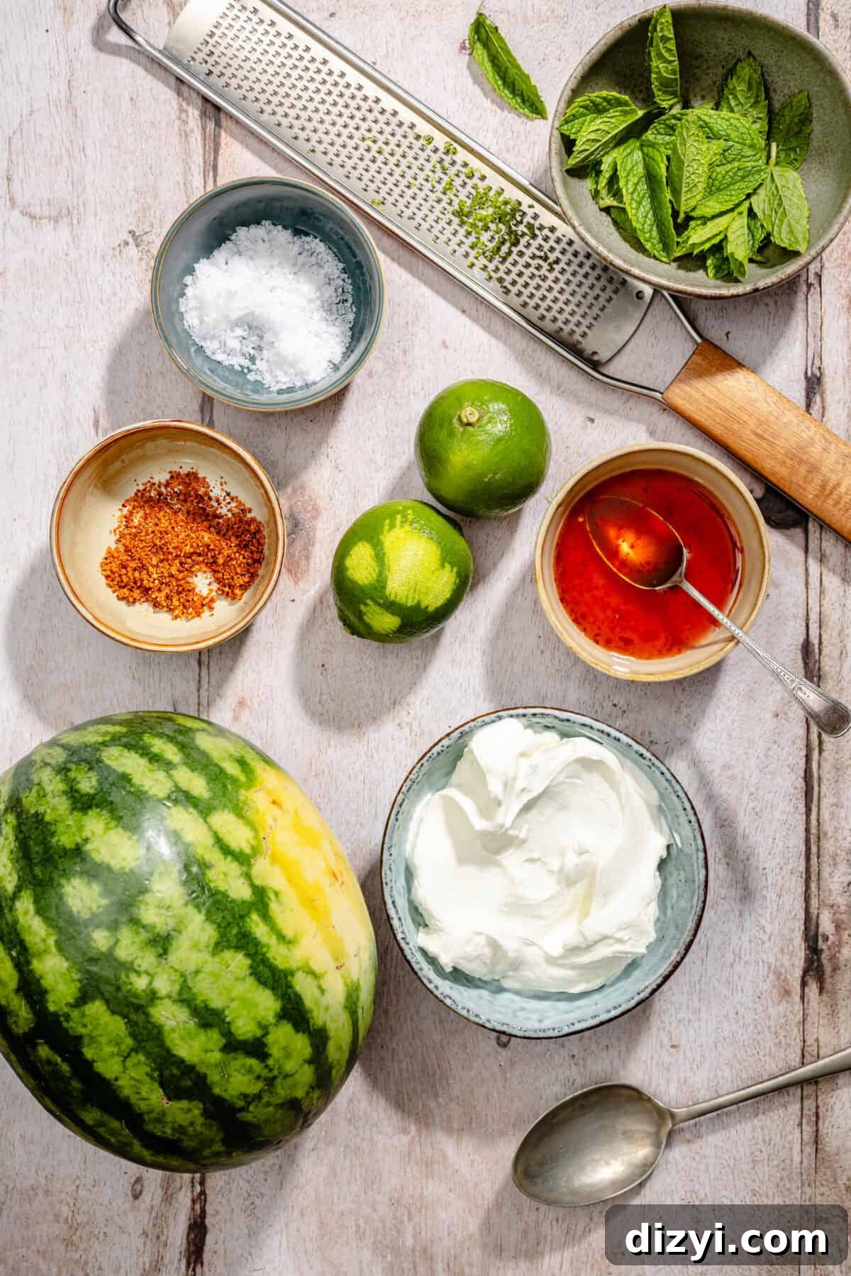 Chili-Lime Watermelon Salad with Labneh and Hot Honey Recipe 4 Ingredients scatter on counter for Chili Lime Watermelon with Labneh and Hot Honey.